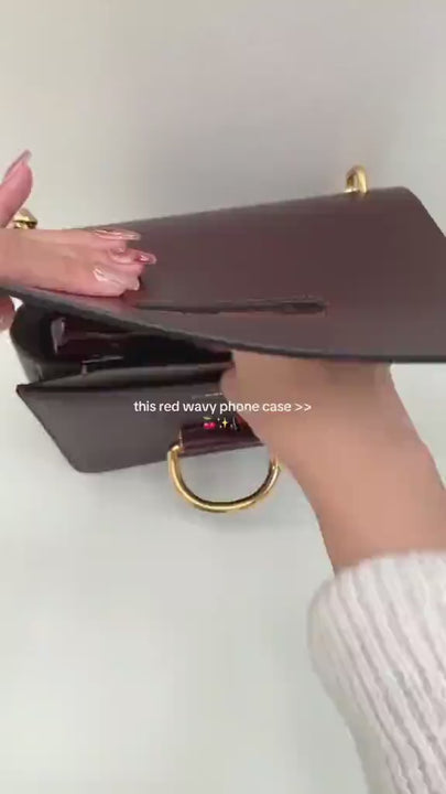 Cherry Wave Phone Case in glossy deep red color with a unique wavy texture and raised camera protection, displayed on a white background.
